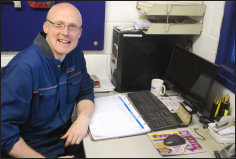Chris at his desk in the Gilesgate Autocare office