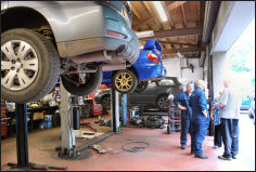 Inside the Gilesgate Autocare workshop with cars up on the lifts